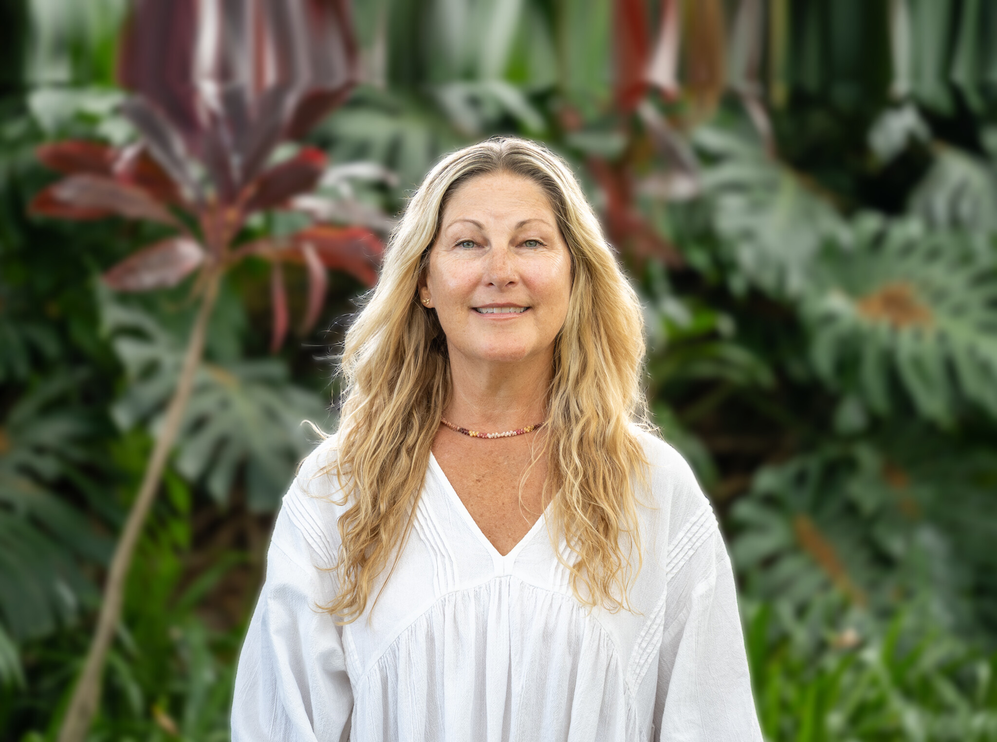 Portrait of Erica Saltiel Levin outdoors against softly blurred greenery